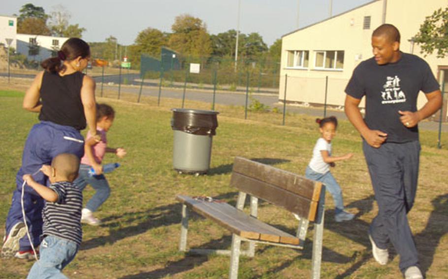 The White family, playing a game of chase on the sports field on Rhein-Main Air Base.