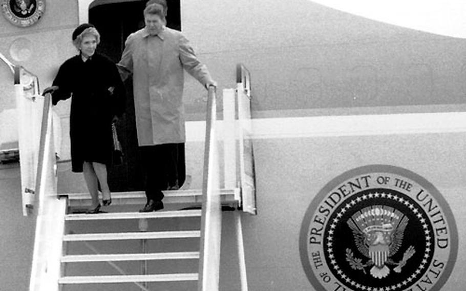 President and Mrs. Reagan step down from Air Force One at Bitburg.