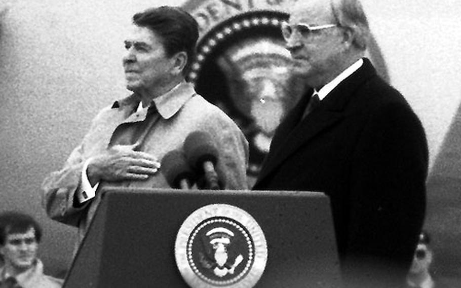 President Reagan and German Chancellor Helmut Kohl stand at attention for the U.S. and German national anthems.