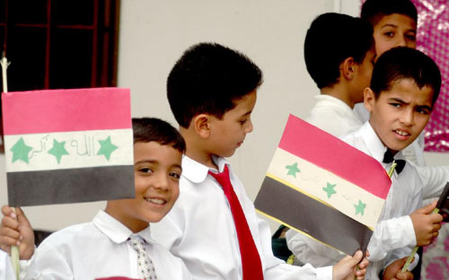 Boys at the primary school in Baghdad&#39;s French Quarter wave homemade Iraqi flags Sunday as their school, badly damaged in the war and its aftermath, was opened with the help of the 308th Civil Affairs Brigade, an Army Reserve unit from Illinois.