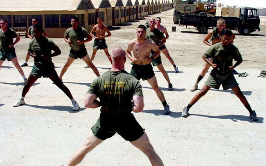 Marines in southern Iraq use spare time to keep fit in the desert heat. Many Marines said they have adjusted to their changing mission very well. (ms# 61p xg)
