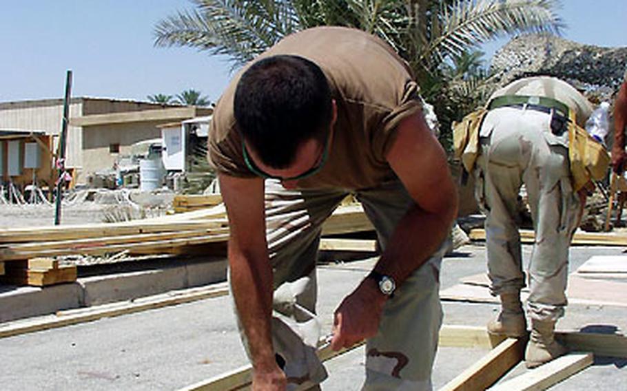 Petty Officer 2nd Class Steve Umfleet of Naval Mobile Construction Battalion 15, out of Kansas City, Mo., helps frame a building in Iraq. The Seabees have stayed busy in Iraq and that, some leaders in the unit say, has helped keep their morale up.
