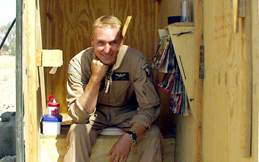 When he’s not flying UH-60 Black Hawk missions over Iraq for the 101st Airborne Division, Chief Warrant Officer 3 Kevin Powell, 32, of the 6th Battalion, 101st Aviation Regiment, builds things. His prize project is this outhouse at Qayyarah West airfield — complete with light, magazine rack, ashtray and padded seat.