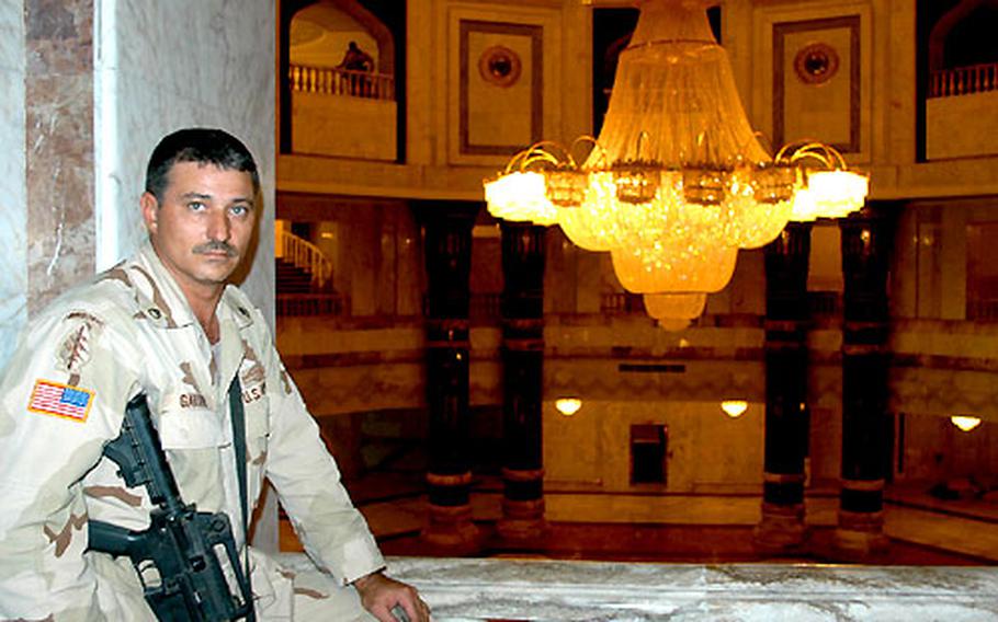 Staff Sgt. Russell Garvin of the 1st Battalion, 152nd Infantry of the Indiana National Guard leans against the second-floor railing in the Al Faw palace at Camp Victory, Iraq, near Baghdad International Airport. Garvin is the palace’s full-time caretaker, doing everything from playing tour guide to Teamster.