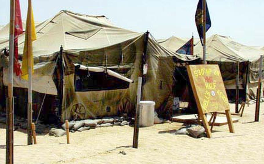 Members of the 530th Military Police Battalion, headquartered in Omaha, Neb., live in large tents at Camp Bucca in southern Iraq.