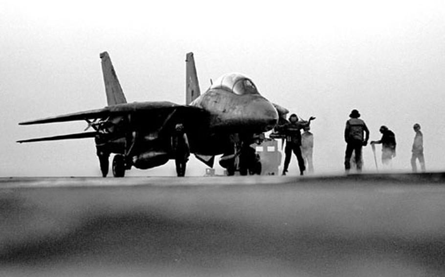 Activity on the flight deck of the USS Saratoga in the Red Sea during Operation Desert Shield in November, 1990.