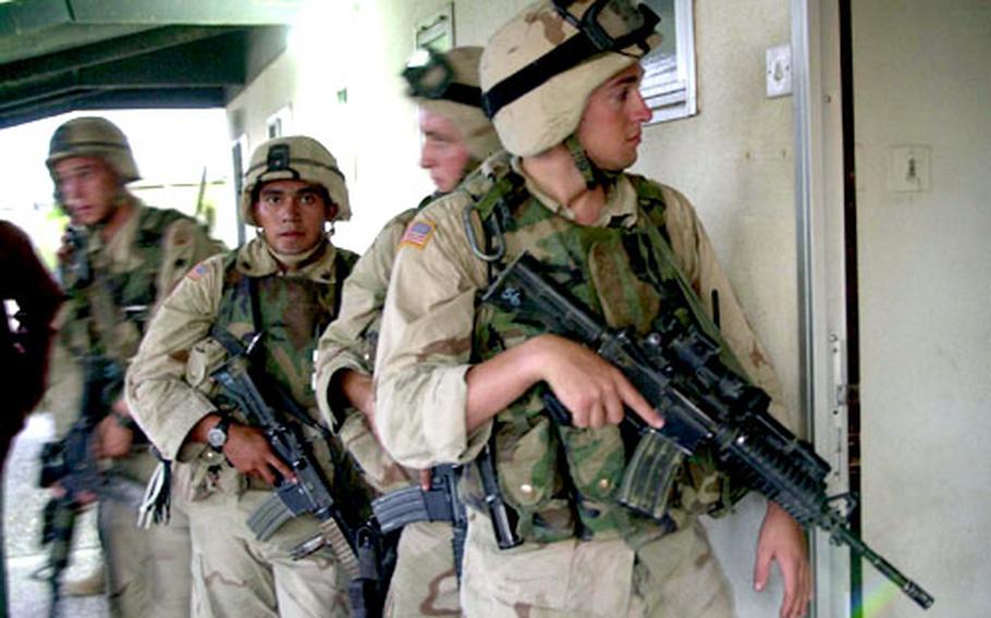 Soldiers with the 82nd Airborne Division prepare to raid a home near Baghdad International Airport in Iraq in August. The soldiers raided the house on a tip that the owner was hiding or had information about surface-to-air missiles.
