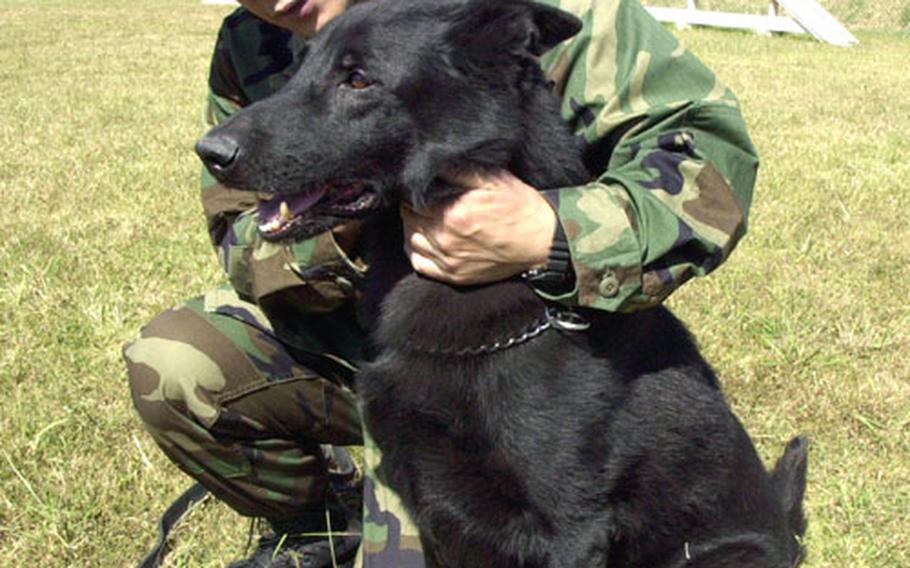 Sentaro Koda, a military dog handler and a 16-year employee of the Sasebo Naval Base Security Detachment&#39;s K-9 unit, adopted his retiring longtime partner Friday afternoon. Koda and Nero, an 11-year-old German shepherd, trained and worked together for several years.