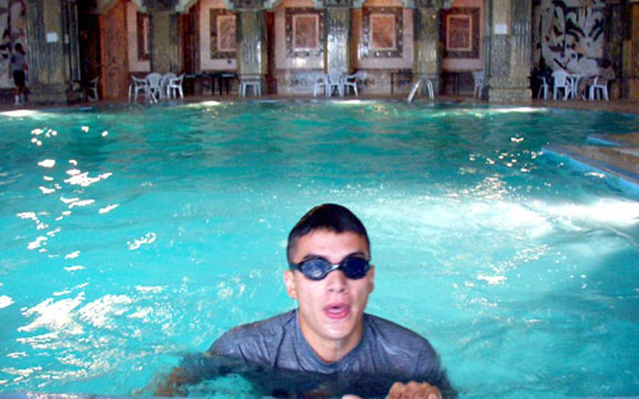Pfc. James Bluebird says laps in one of Saddam Hussein’s favorite pools in Tikrit beats running in the blistering heat any day.