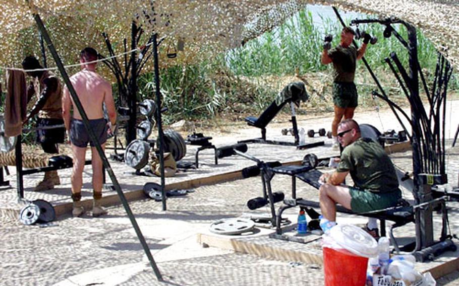 Lifting weights has a refreshing effect on many troops. While some have access to equipment such as benches and dumbbells, others lift sandbags or other heavy objects.