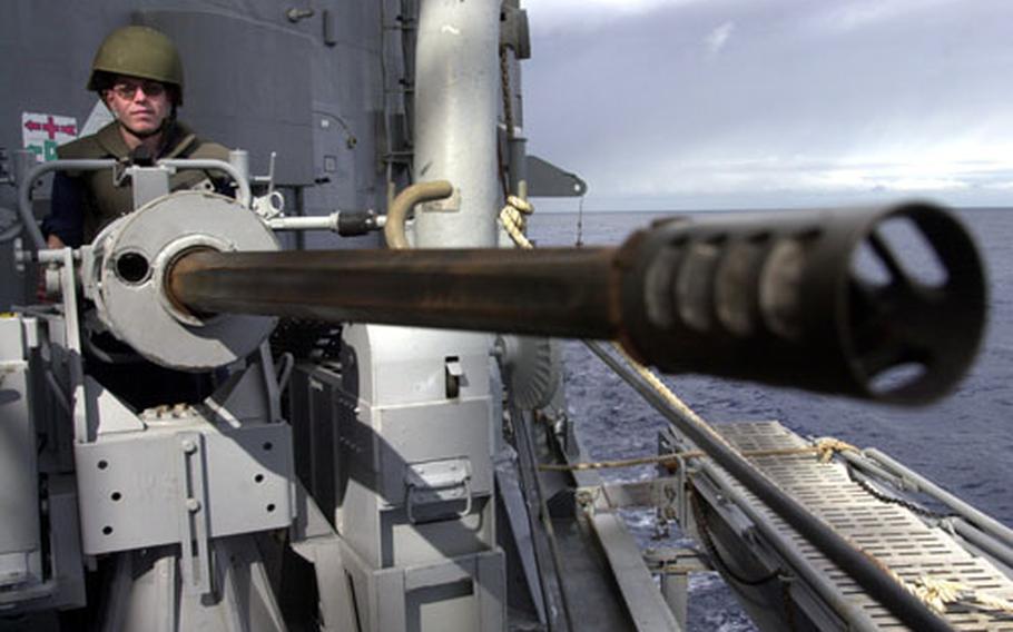A U.S. sailor aims a 25 mm chain gun aboard the USS Nicholas during a multinational exercise in the Mediterranean Sea on Friday.