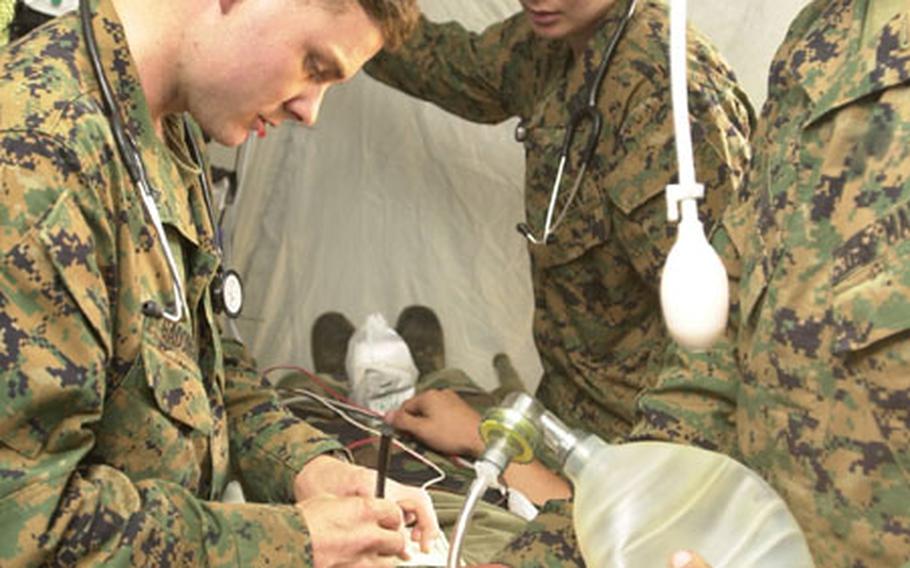 Corpsmen with the 3rd Medical Battalion on Okinawa treat and analyze a "patient" who is waiting to go into the operating room at the Forward Resuscitative Surgical System during exercise Autumn Endeavor Oct. 23 at Camp Hansen.