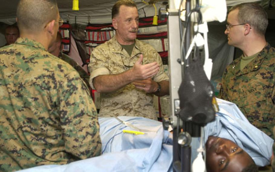 Navy Capt. Stephen F. McCartney, the Group Surgeon for 3rd Force Service Support Group, talks with 3rd Medical Battalion Surgeons in the Forward Resuscitative Surgical System during exercise Autumn Endeavor at Camp Hansen Oct. 23.