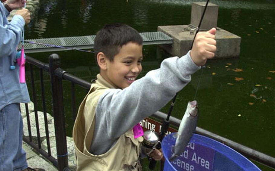Jacob Bautista, 10, can&#39;t help but smile after trapping his first trout from Camp Zama&#39;s Dewey Pond during Saturday&#39;s fishing derby.