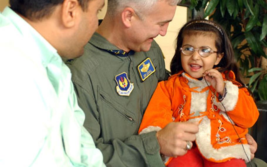 Brig. Gen. Erwin F. Lessel III, 86th Airlift Wing commander, Ramstein Air Base, Germany, talks to Maraim, 4, one of the 18 Iraqi children who arrived Oct. 6.
