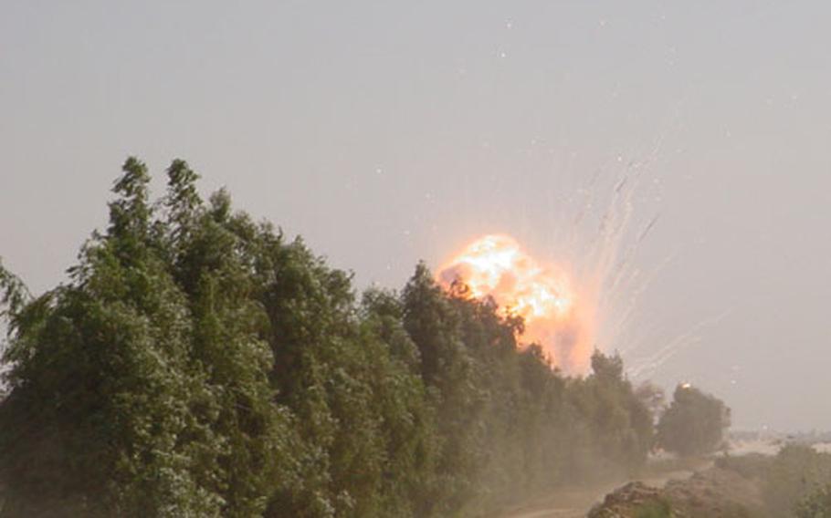 A fireball rises above an Iraqi vineyard after Explosive Ordnance Disposal personnel triggered 140 pounds of C-4 explosives placed on three SA-6 missiles and its launcher. The photo was taken from nearly a mile away.