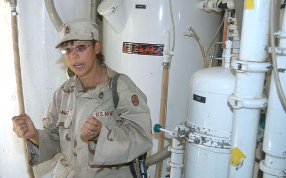 Sgt. 1st Class Maria Hammer of the 692nd Quartermaster Battalion at LSA Anaconda, Iraq, explains how the ROWPU — Reverse Osmosis Water Purification Unit — makes water for the base, which consumes 400,000 gallons a day.