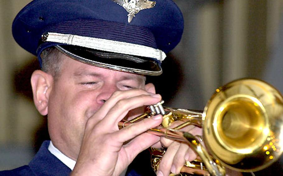 Master Sgt. Keith Hansen, a member of the Pacific Air Forces Band-Asia at Yokota Air Base, plays taps during a repatriation ceremony at the base Tuesday night.