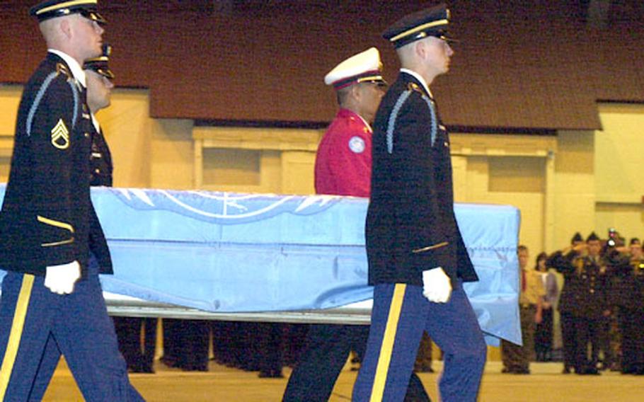 Members of the U.N. Command Honor Guard from Yongsan, South Korea, carry a casket holding what are believed to be remains of a missing GI from the Korean War.