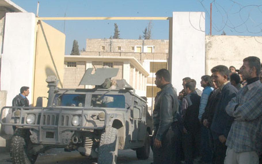 Iraqis line up outside the Transportation Jail in Mosul, Iraq, on Saturday for visitations with detainees. Inmates are allowed to talk with each visitor for 10 minutes on Saturdays.