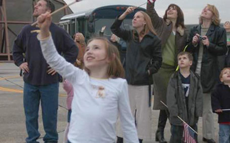 Stephanie Ramer, 8, watches as several A-10 Thunderbolt II airplanes fly over Spangdahlem Air Base on Monday. The last eight members of the 81st Fighter Squadron returned from Bagram, Afghanistan, after a six-month mission.