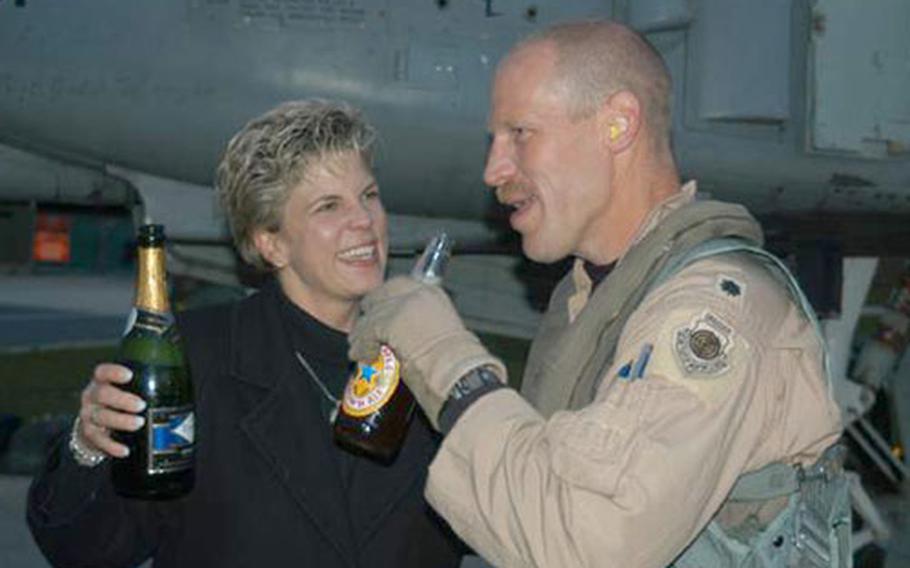 Lt. Col. Patrick Malackowski and his wife, Carol, share a drink after he returned Monday from Bagram, Afghanistan. Malackowski, commander of the 81st Fighter Squadron, returned with seven others from the squadron - the last of the squadron to finish the six-month deployment.