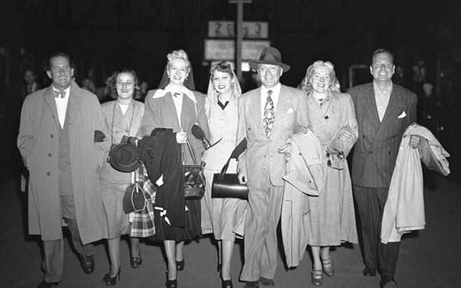 Comedian Jack Benny and his entourage arrive in Frankfurt to begin a four-day troop tour. They are, left to right, Frankie and Mrs. Remley, Marilyn Maxwell, Mary Livingstone, Jack Benny, Alice Faye and Phil Harris.