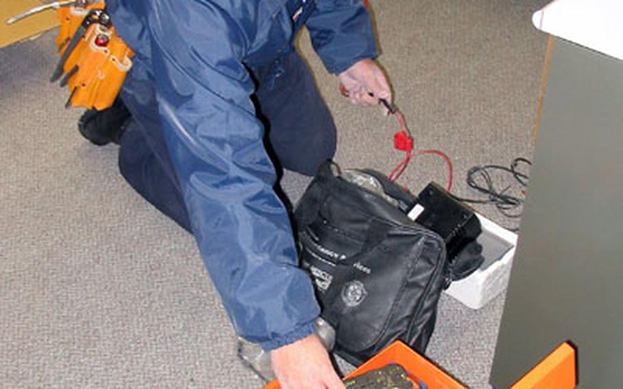 Shunsuke Matsuo, the skilled technician firefighters say can rig or repair anything, searches for the just right gadget among his tools on Tuesday afternoon while finishing some of the final wiring and other projects at Station 15.