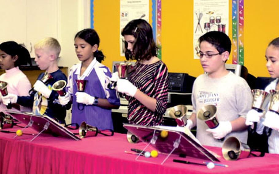 Members of the handbell choir at Amelia Earhart Intermediate School at Kadena Air Base, Okinawa, practice Monday for their holiday concert.