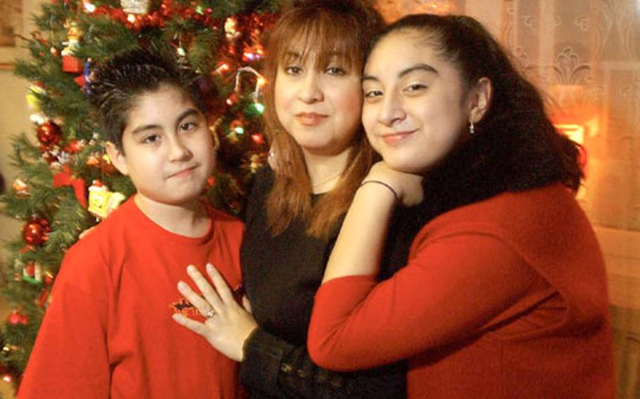 Portrait of the Jacquez family, Rick, 12, Cristina, and Alexandra, 13, at Langen military family housing in Germany on Monday. Cristina says this isn&#39;t the first time her husband, Sgt. Enrique Jacquez-Balderrama has been away from home for the holidays, but the fact that he&#39;s in Iraq has the family, "stressed, nervous and very concerned for his safety." Jacquez-Balderrama is member of the 32nd Signal Battalion, in Darmstadt, Germany, and has been deployed to Iraq since February. The Jacquez&#39;s have sent several letters, "boxes of goodies," and e-mails to Enrique to help him get through the holidays.