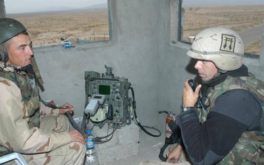 Spc. Bruce Pinson, 27, left, an avenger gunner from Pell City, Ala., and Spc. Ronald Brown, 34, a stinger gunner from Minneapolis, man a guard post at the Range 54 camp in Sinjar, Iraq. The soldiers are with Battery C, 2nd Battalion, 44th Air Defense Artillery Regiment, in support of 3rd Brigade, 101st Airborne Division.