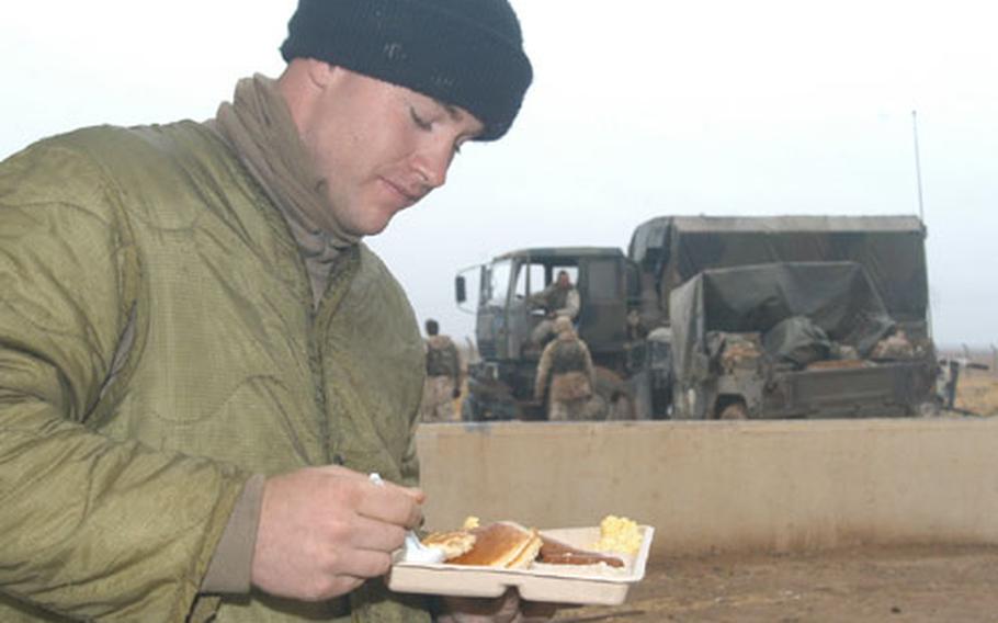 Pfc. Jeremy Davidson, 21, from Cheyenne, Wyo., enjoys some hot breakfast at the remote Objective Wolf camp, from which he guards the Iraq-Turkey pipeline.