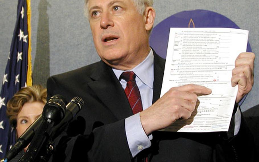 Illinois Lt. Gov. Pat Quinn displays a state income tax form that allows individuals to make tax-deductible donations to a fund to assist military families facing reduced income due to the deployment of Guard and Reserve families. Quinn and four other state officials spoke at the National Press Club on Wednesday.