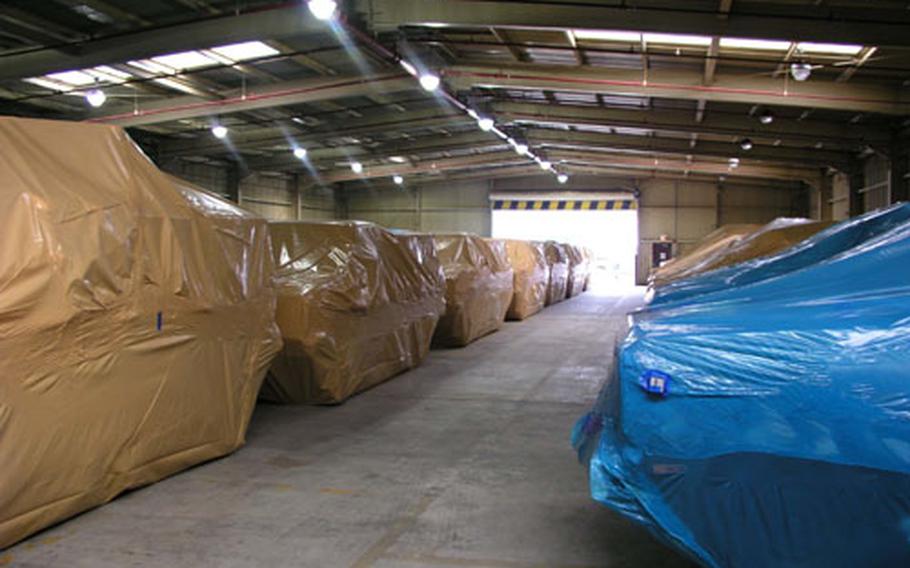 Some of the vehicles kept under plastic shrink-wrap at Osan Air Base, South Korea.