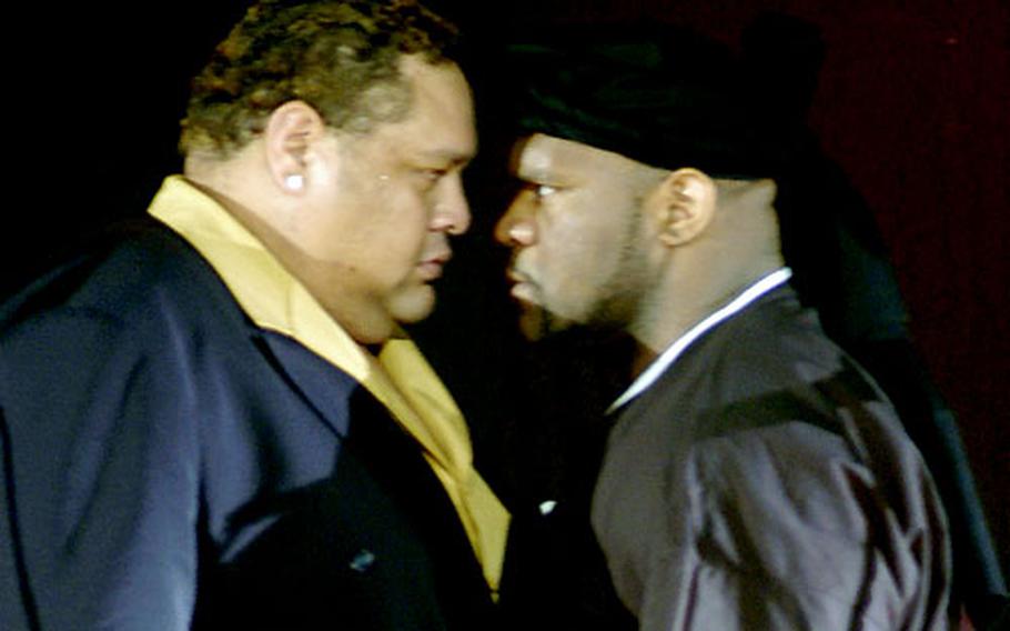 Bob "The Beast" Sapp and former Sumo Wrestler Akebono stare each other down before the start of the 2004 K-1 fight at the Okinawa Convention Center.