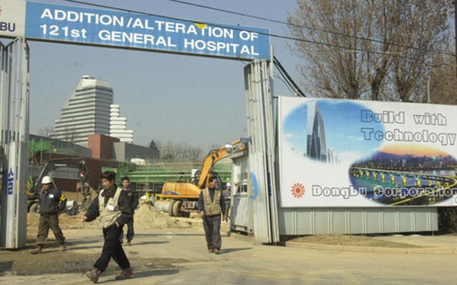 Construction workers at the 121st General Hospital on Yongsan Garrison go on their lunch break. Military officials say they&#39;re going ahead with the final phase of a $70.2 million renovation despite an agreement to move all forces off Yongsan by 2007.