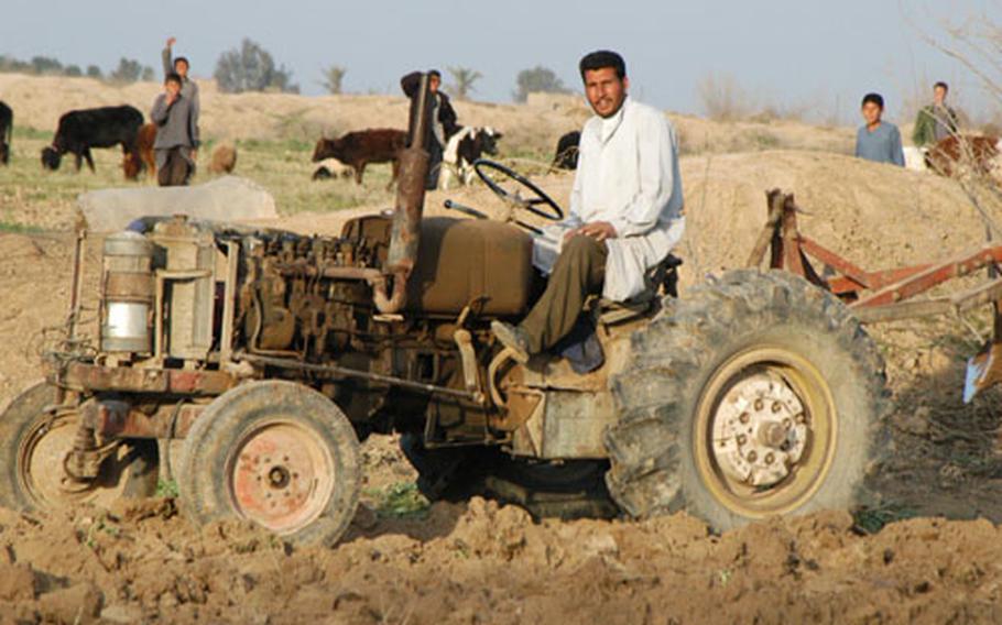 Iraqi farm tractors are old but do the job, like this one, plowing a field near Balad, Iraq.