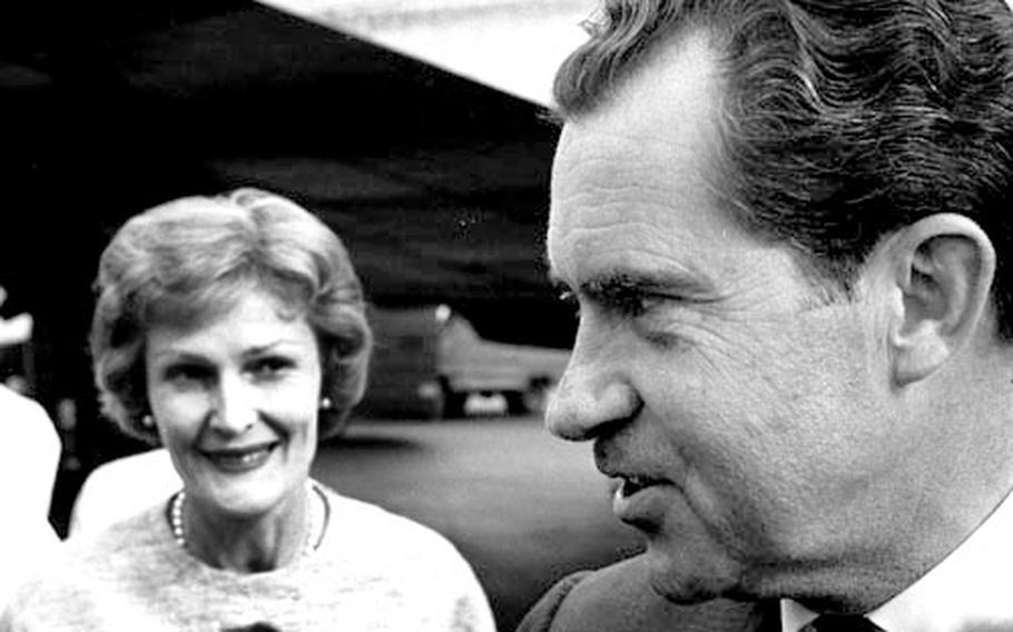 Pat Nixon watches as her husband, the former vice president, talks to reporters at the Frankfurt airport.