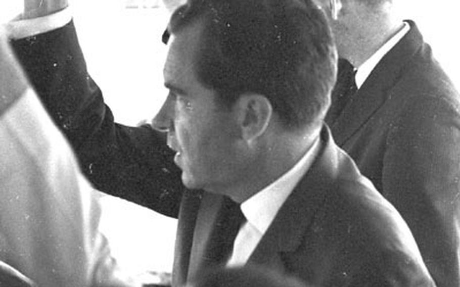 Former Vice President Nixon rides a shuttle bus at the Frankfurt airport.