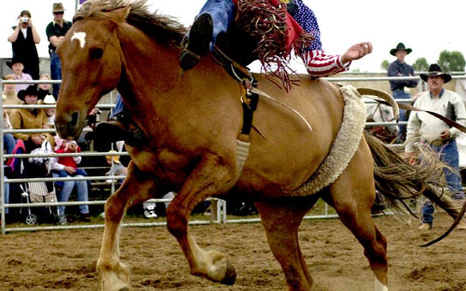 Stan Schofield hangs on for the mandatory eight seconds during the bareback competition at an European Rodeo Cowboy Association event in Griesheim, Germany, in 2002.