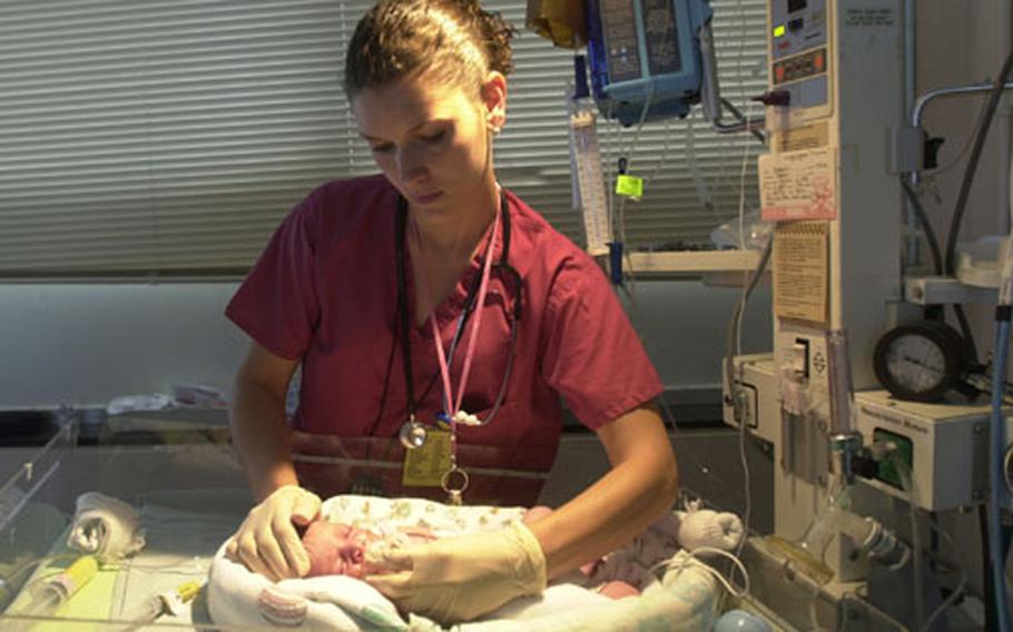 Heather Gregg, a nurse in the U.S. Naval Hospital Okinawa&#39;s Neonatal Intensive Care Unit, checks on Cheyanne Kendrick March 22.