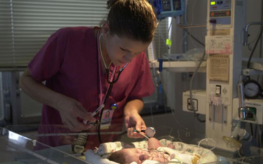 Heather Gregg, a nurse in the U.S. Naval Hospital Okinawa&#39;s Neonatal Intensive Care Unit, checks on Cheyanne Kendrick March 22.