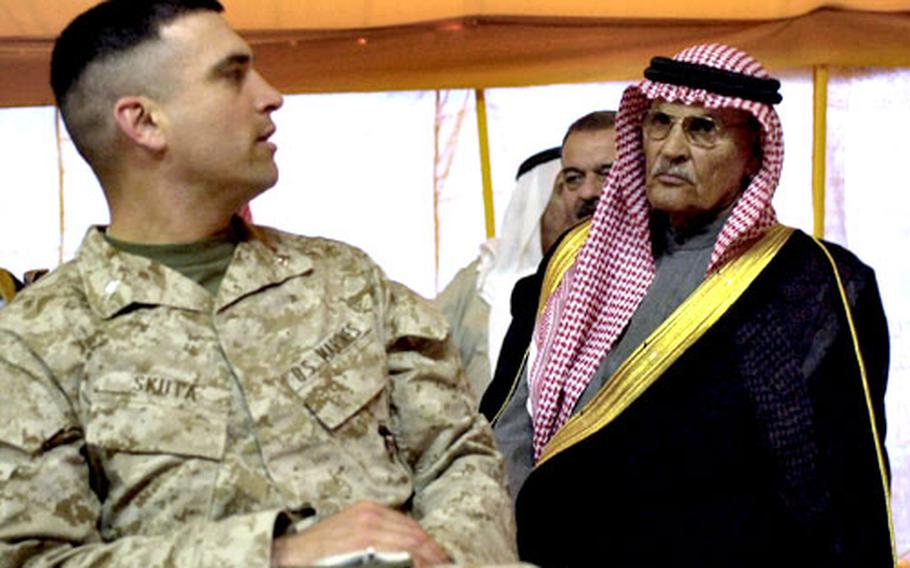 A Marine turns to listen to an Iraqi sheik during a meeting at Al-Asad Air Base in western Iraq on March 9.