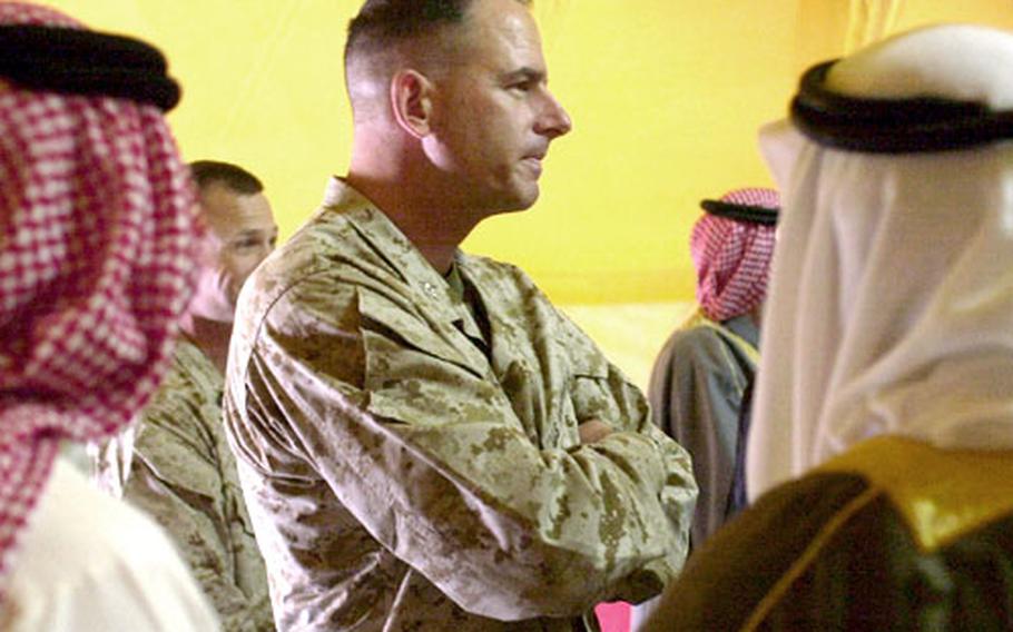 Col. Craig Tucker, commander of the 7th Marine Regiment, listens to a group of sheiks talk during a meeting at Al-Asad Air Base in western Iraq last month.