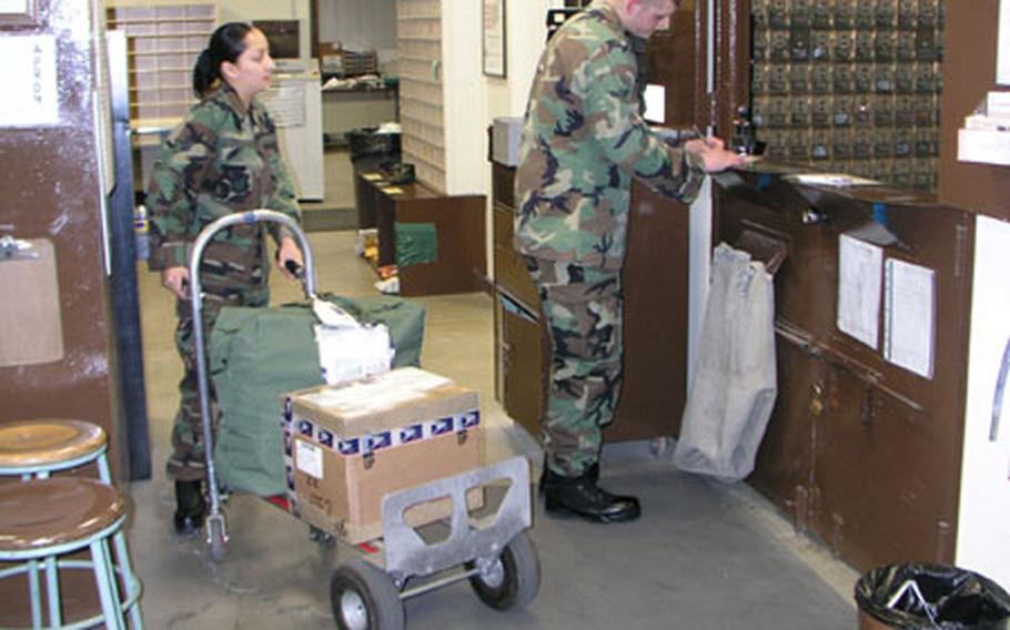 Airmen at the post office on Osan Air Base, South Korea, wait on customers picking up packages and other mail Thursday afternoon. The base, which received an "outstanding" rating on an annual Pacific Air Forces inspection earlier this week, is the busiest within PACAF based on the amount of mail processed and the number of postal staffers available to process it. At left is Senior Airman Delia Menchaca, at right Airman Anthony Powell, both postal clerks with the 51st Communications Squadron.