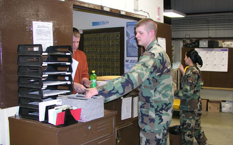 At Osan Air Base, South Korea, Airman Anthony Powell waits on a customer at the base post office, which is the busiest within Pacific Air Forces based on the total volume of mail processed and the number of postal staffers available to process it.