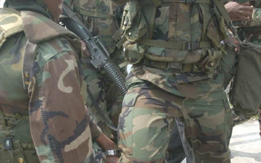 Pfc. Lateidria Mitchell and Pfc. Lee Jin-ho detain Pfc. Paris Woods, who played the role of an infiltrator at Madison Site, a microwave signal relay site on top of Kwangyo Mountain near Suwon.