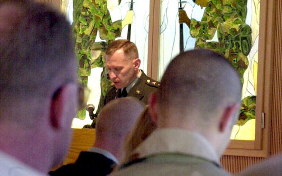 Chaplain (Maj.) Peter Brzezinski bows in prayer during a memorial ceremony Tuesday in Vilseck, Germany, honoring three 1st Infantry Division soldiers of the Vilseck-based 3rd Brigade. Staff Sgt. Victor A. Rosales, Sgt. William Cody “Tex” Eckhart and Spc. Allen J. Vandayburg were killed in separate incidents in Iraq last week.