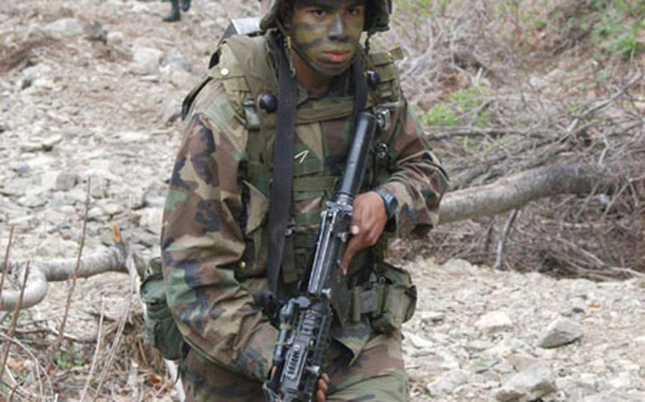 Soldiers from the 2nd Infantry Division&#39;s C Company, 1st Battalion, 503rd Infantry Regiment march up a creekbed during training at Blackhawk Range this week.