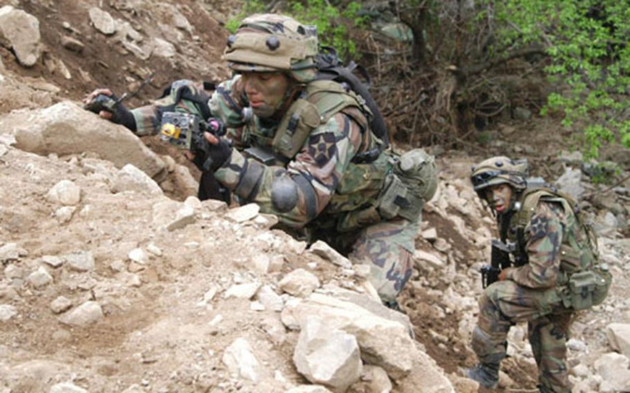 Soldiers from the 2nd Infantry Division&#39;s C Company, 1st Battalion, 503rd Infantry Regiment clamber out of a creekbed during training at Blackhawk Range this week.